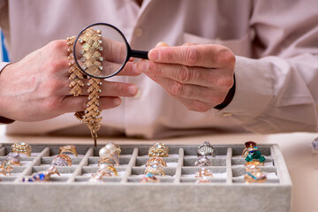 Old male jeweler at workshop