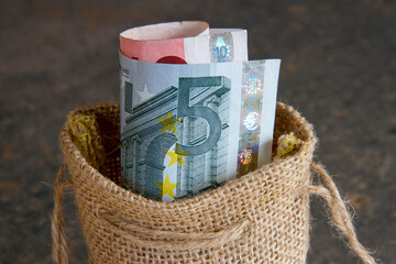 Euro notes in a brown hessian bag.