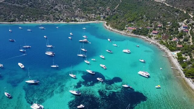 Aerial, zoom in, anchored boats off the coast of Croatia 