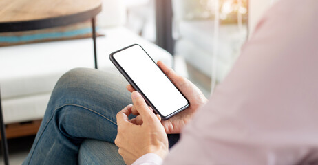 cell phone mockup blank white screen.woman hand holding texting using mobile on desk at coffee shop.background empty space for advertise.work people contact marketing business,technology