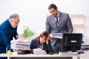 Two male and one female employees working in the office