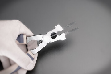 Hand holds a multifunction pliers