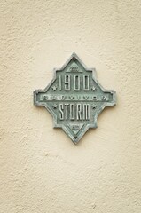 Vertical green bronze plaque on historic building in The Strand of Galveston, Island, Texas...