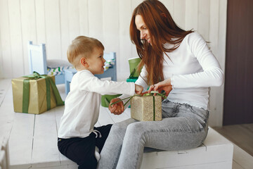 Mother with child. Family at home. People with presents.