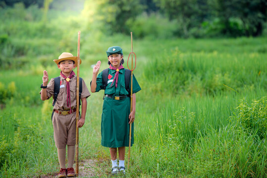 Asian boys and girls scouts students in Thailand Wearing a boy scout's uniform Going camping and hiking in the outdoor forest