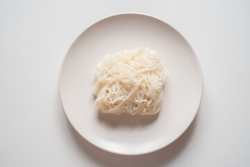 Rice Stick Noodles on plate on white background