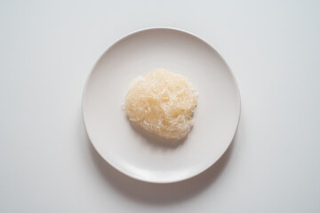 Boiled vermicelli on plate on white background