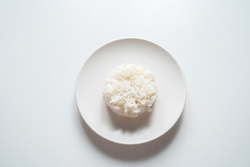 white rice in a bowl on white background