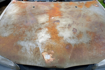 Car hood metal rust sandpapered smooth with polishing and scratch marks seen on rusty metal...