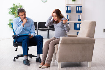 Pregnant woman visiting young male psychologist