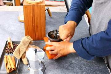 the barista grinding roasted coffee beans in grinded