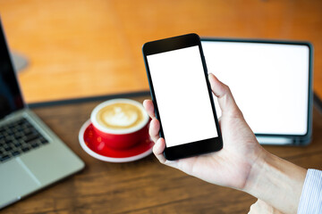 man hand using smartphone In the coffee shop,Screen blank with clipping path