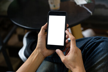 man hand using smartphone In the coffee shop,Screen blank with clipping path