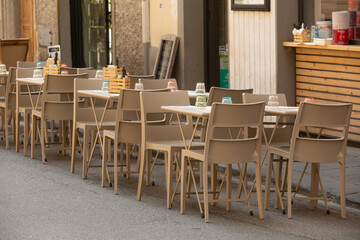 Tables and chairs set up outside a restaurant