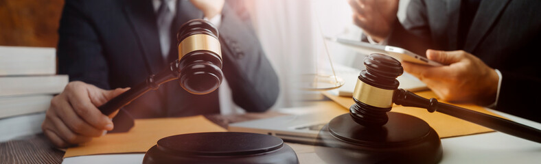 Business and lawyers discussing contract papers with brass scale on desk in office. Law, legal services, advice, justice and law concept picture with film grain effect