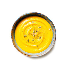Roasted pumpkin or carrot soup with  pumpkin seeds  isolated on white background