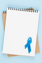 blue prostate ribbon on open notebook