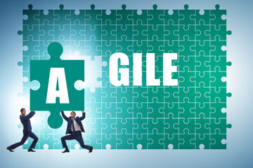 Agile concept with businessman putting jigsaw puzzle together