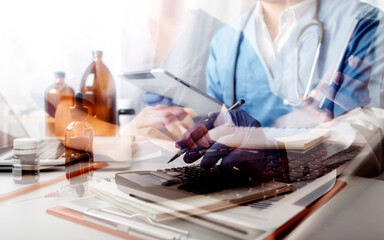 Medical technology concept The doctor works with mobile phones, headphones and tablets. Digital laptop Pressing the calculator in the modern office at the hospital in the morning