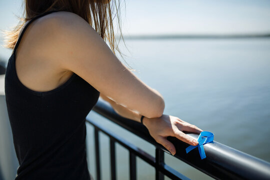 blue ribbon in hands of the girl