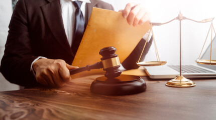 justice and law concept.Male judge in a courtroom on wooden table and Counselor or Male lawyer...