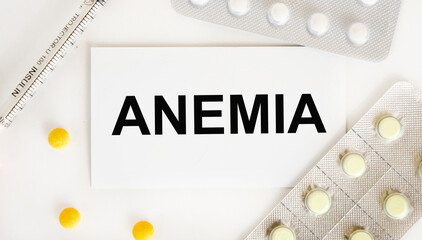 On the card is the text of ANEMIA, around the blister with pills and a syringe.