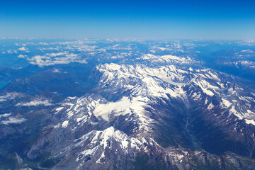 Fototapeta na wymiar The view from the airplane window on a picturesque mountains landscape