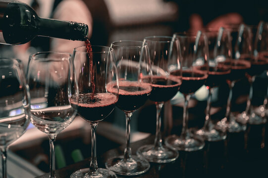 Bartender pouring red wine into a wine glass..Restaurant, beverage, alcoholic beverage concept.