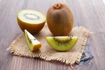 Kiwi fruit and slide on a close-up wooden table