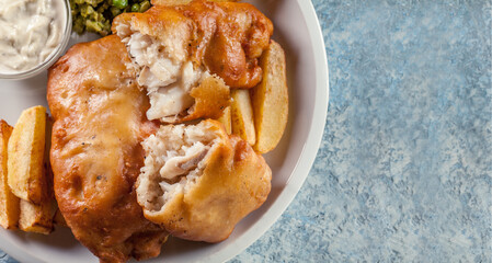 Fish in beer batter and chips with green pea and tartar sauce