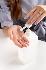 Woman using sterilizer for hands