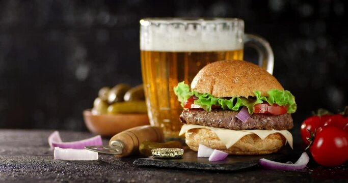 Fragrant burger with beer on a stone board. 