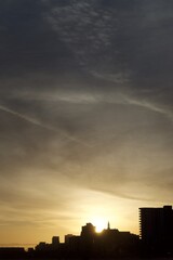 Dramatic sunset along the Long Beach skyline with clouds