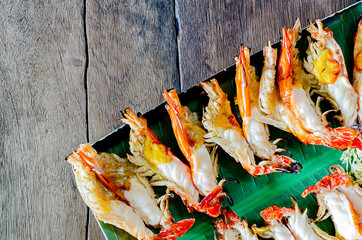 Obraz na płótnie Canvas Charcoal grilled river prawns on wooden table. Thailand famous dish.