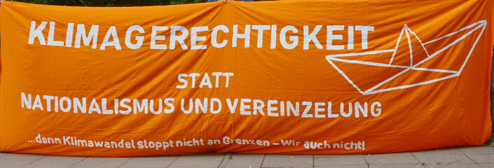 Protest against climate change with the German inscription: Climate justice instead of nationalism,...