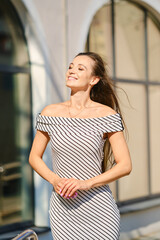 Portrait of young woman in striped dress