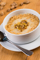 Turkish Desserts milk puding; Keskul, sutlac on wood board