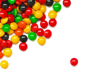 Background of chocolate candy with colored glaze isolated on white background. Scattered multicolored candy