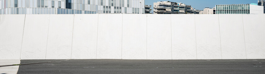 Urban landscape with white wide wall. Copy space for text or design