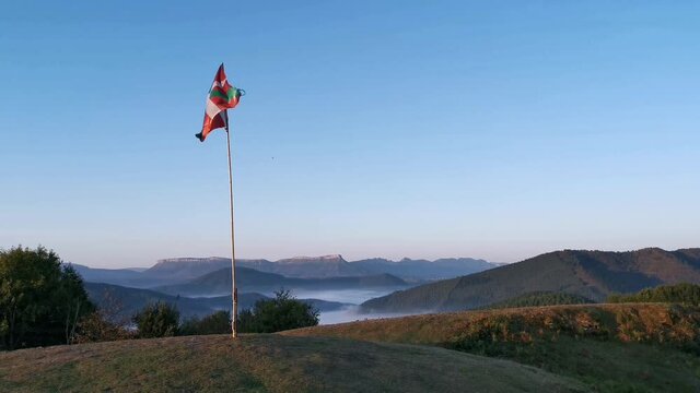 Flag of the Basque Country waving at mountain