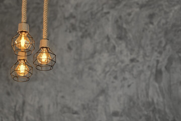 Decorative antique edison style light bulbs against Bare cement wall background