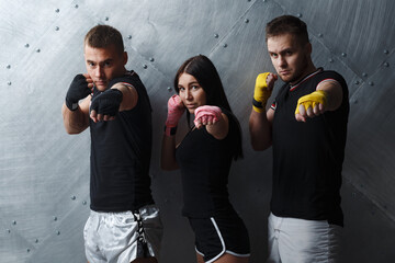 Three boxers man and woman posing before fighting muay thai boxing
