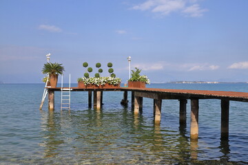 Lake Garda Pier.  The view along a wooden pier on the banks of Lake Garda in North East Italy.