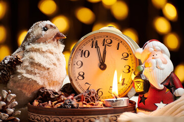 christmas decoration in rustic style and holiday lights background, still life on dark backdrop, a stuffed bird and other
