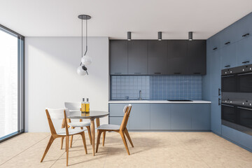 Modern white and blue kitchen with dining table