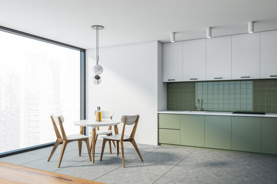 Panoramic white and green kitchen with dining table