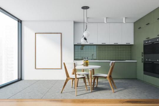 Modern white and green kitchen with dining table and poster