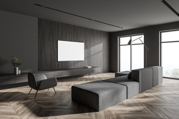 Stylish gray and wooden living room corner with sofa and poster