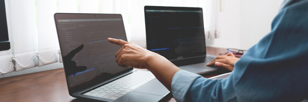 Software developer or programmer working data debugging improvement binary algorithm on desktop pc in a software develop company office.