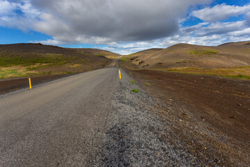 Fototapeta premium Typical Icelandic landscape with asphalt road, Iceland.